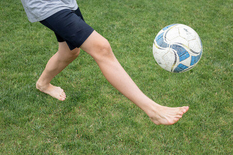 barefoot juggling soccer ball