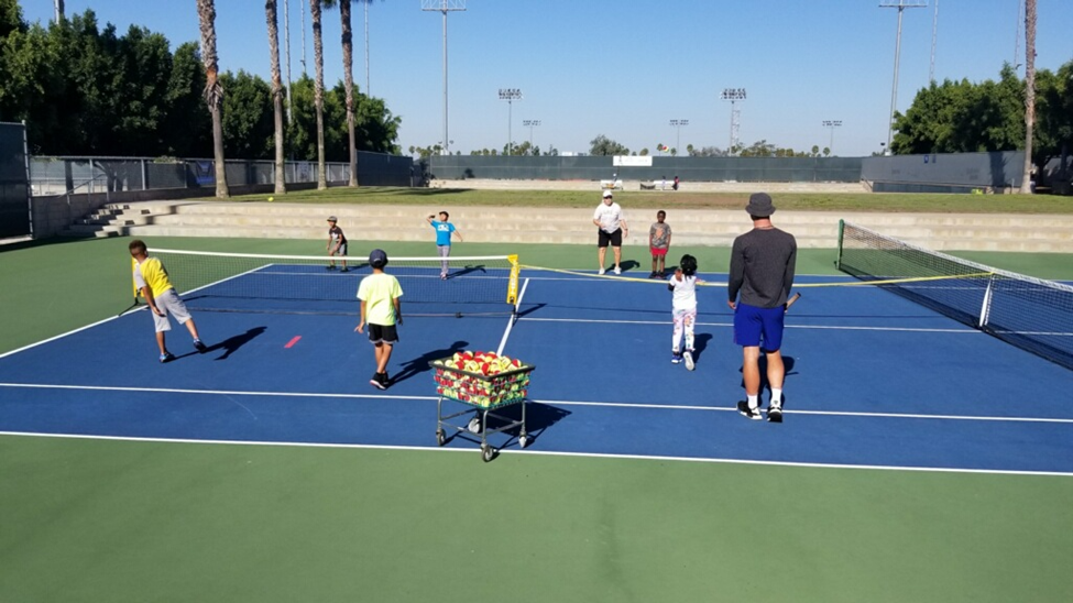 group of people playing tennis group of people playing tennis
