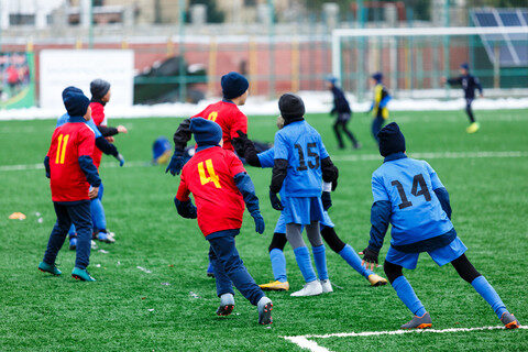 kids playing soccer in the cold